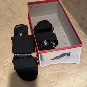 Black “stretch” short heel slides.